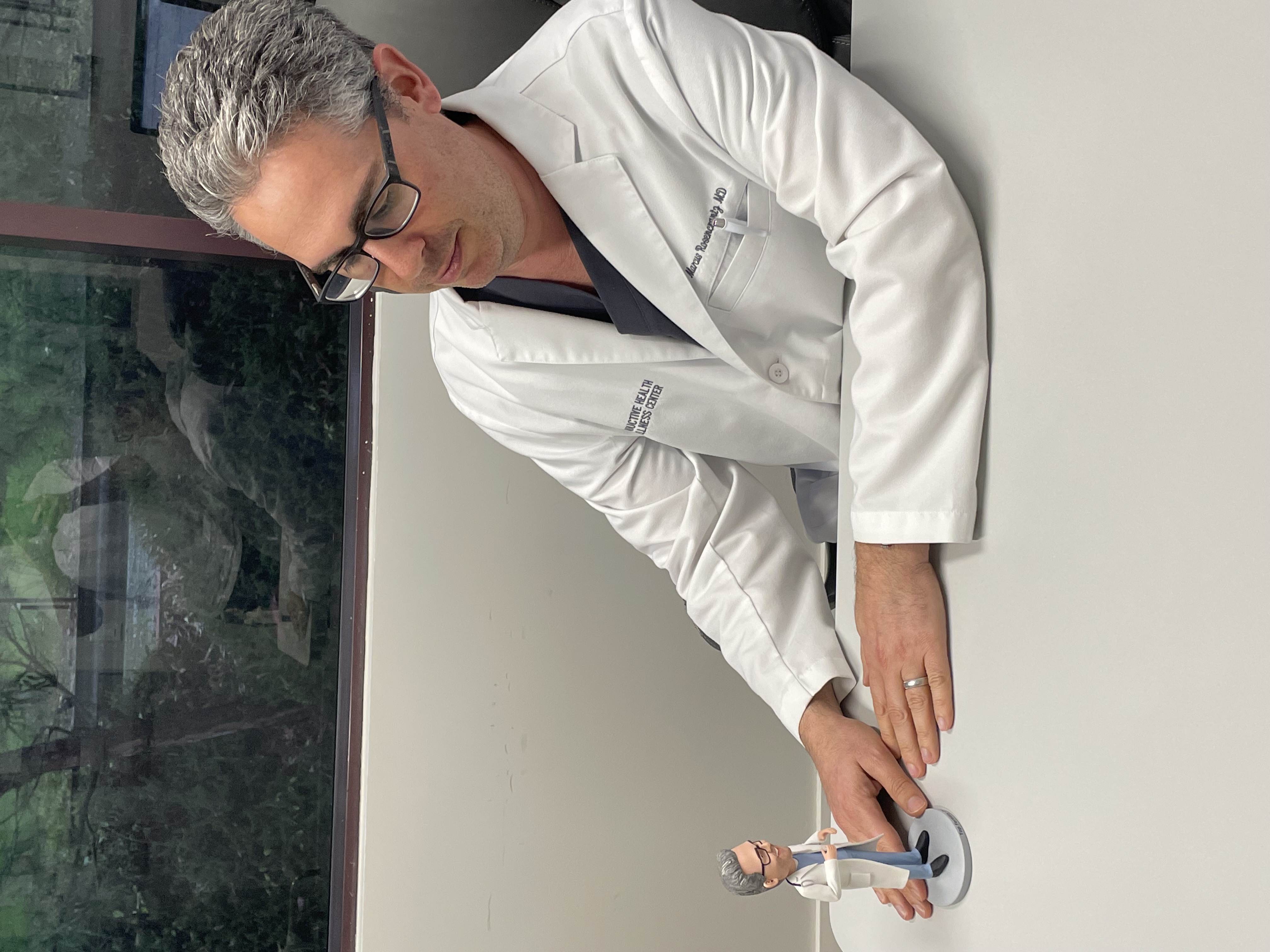 Dr. Rosencrantz with a custom bobblehead made in his likeness, a small branding touch that helped patients connect with him